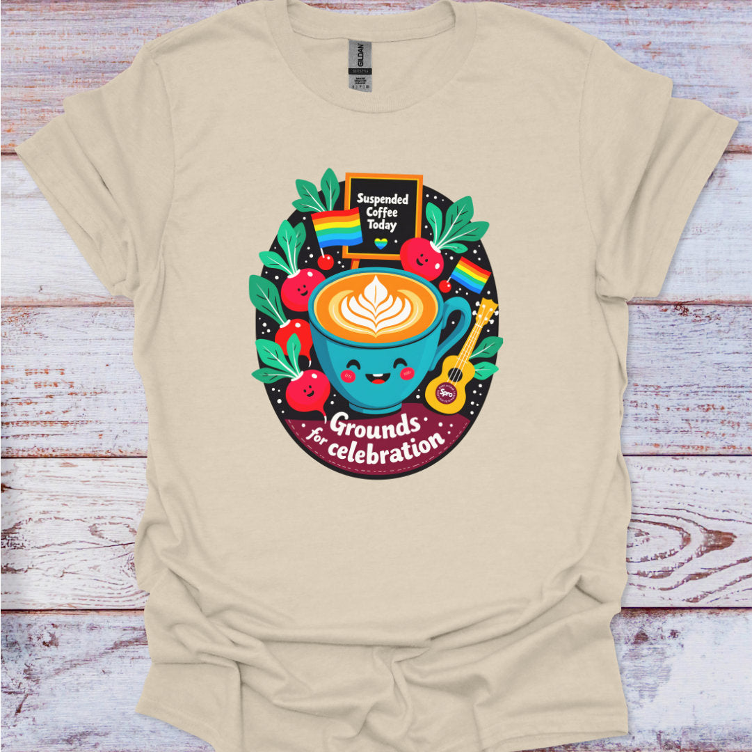 Beige t-shirt with a colorful graphic design featuring a coffee cup and text on a wooden surface.