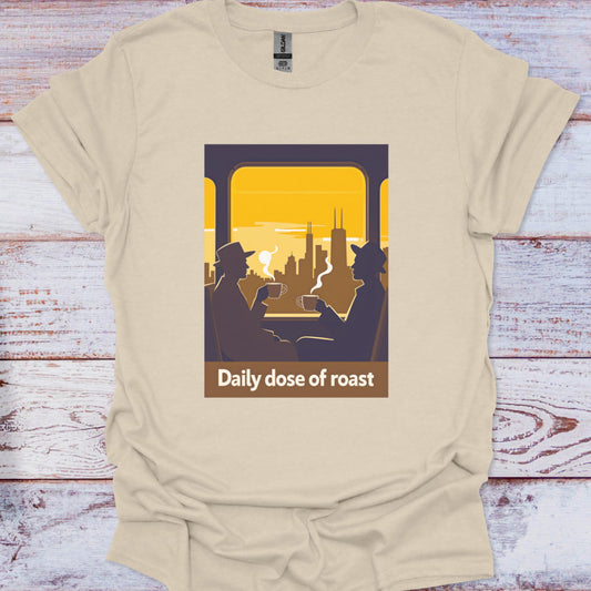 Beige t-shirt with graphic design of two people on a train looking at a cityscape with 'Daily dose of roast' text.