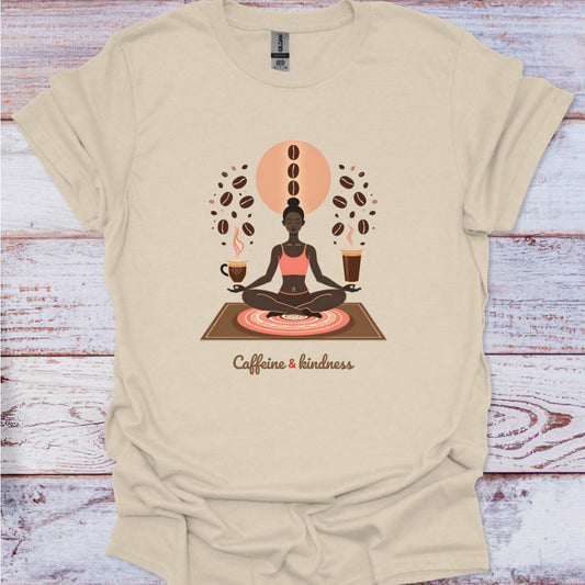 Beige t-shirt with a graphic of a person meditating surrounded by coffee beans and cups on a wooden surface.