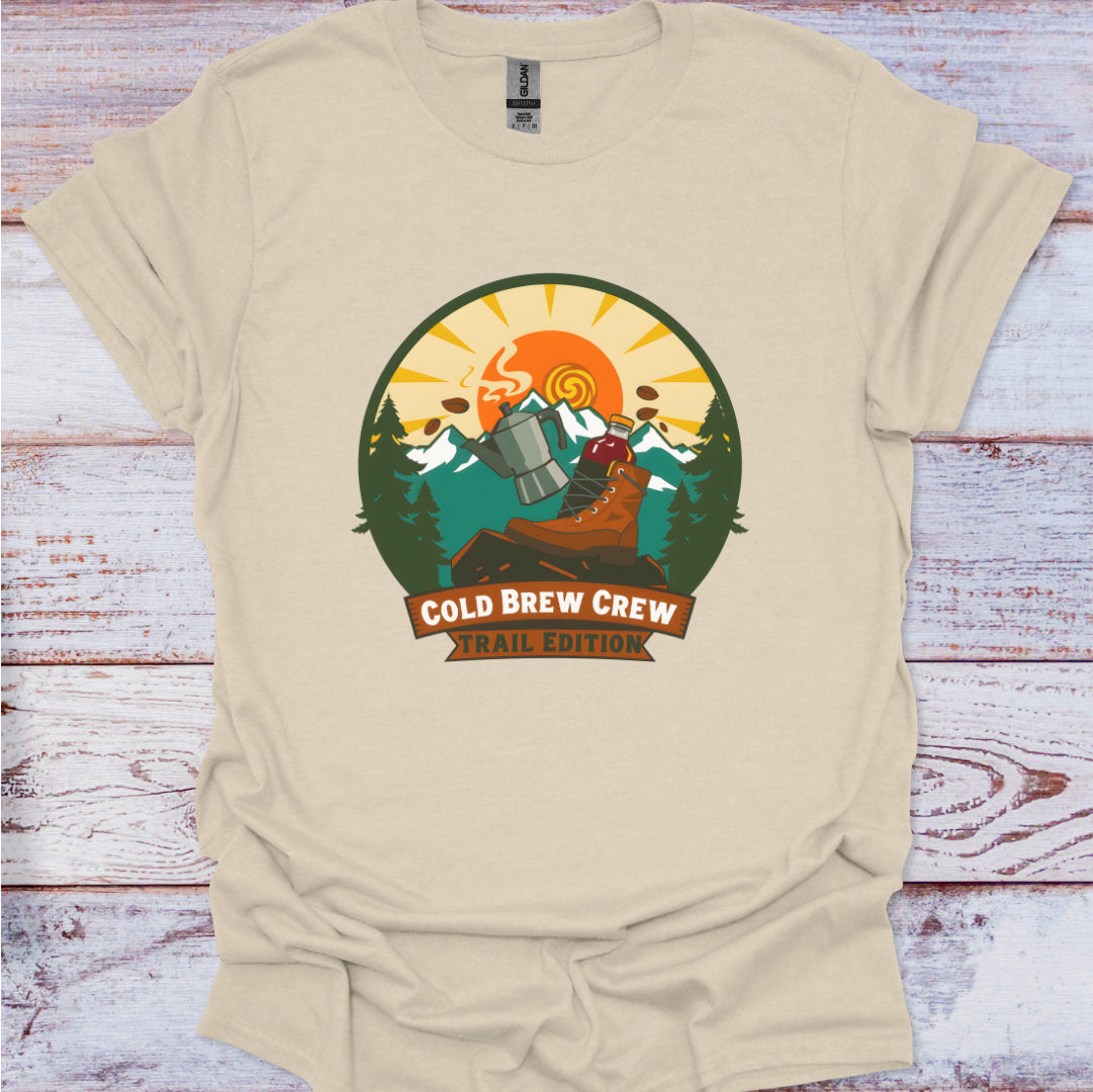 Beige t-shirt with 'Cold Brew Crew' graphic on a wooden surface