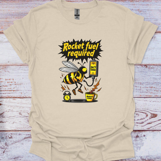 Beige t-shirt with a graphic of a bee and coffee cup on a wooden surface
