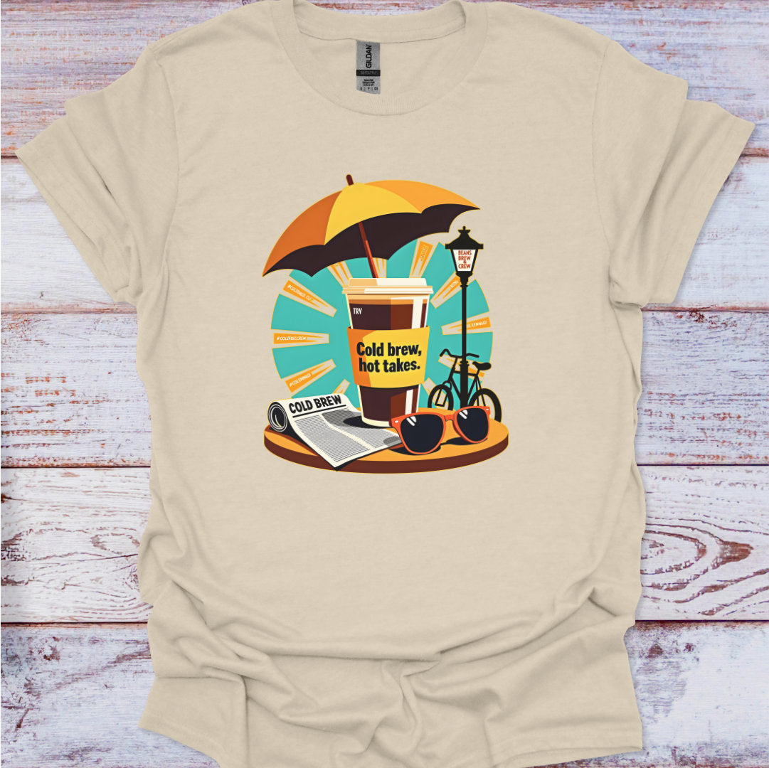 Beige t-shirt with a graphic design of a coffee cup, umbrella, and bicycle on a wooden surface.