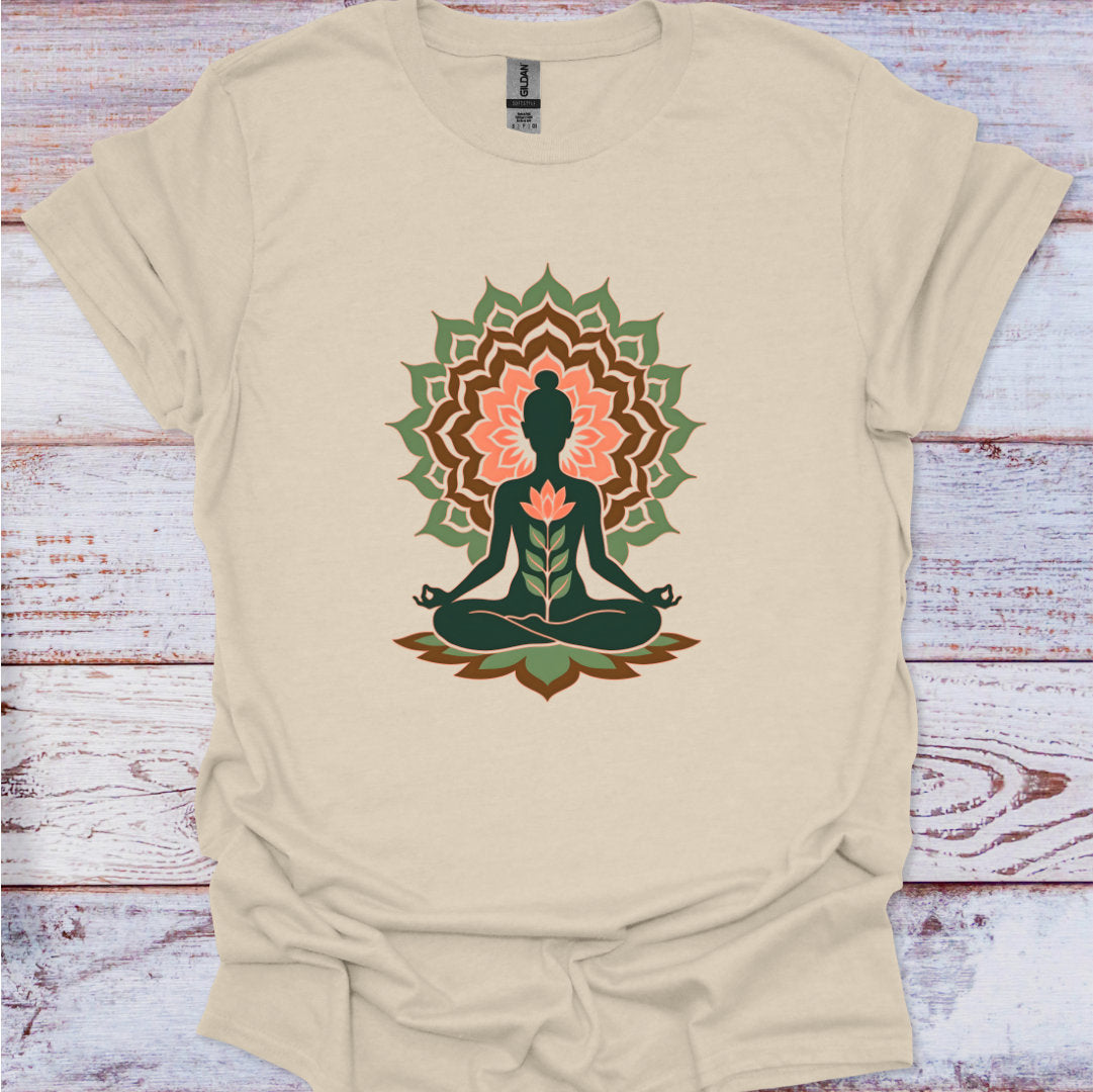 Beige t-shirt with a meditating figure and lotus flower design on a wooden surface
