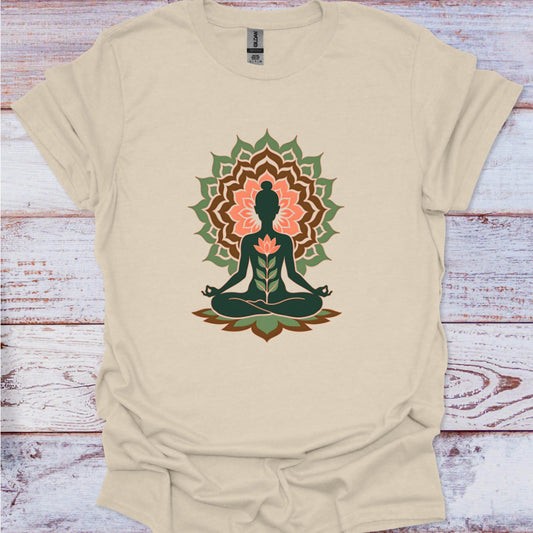 Beige t-shirt with a meditating figure and lotus flower design on a wooden surface