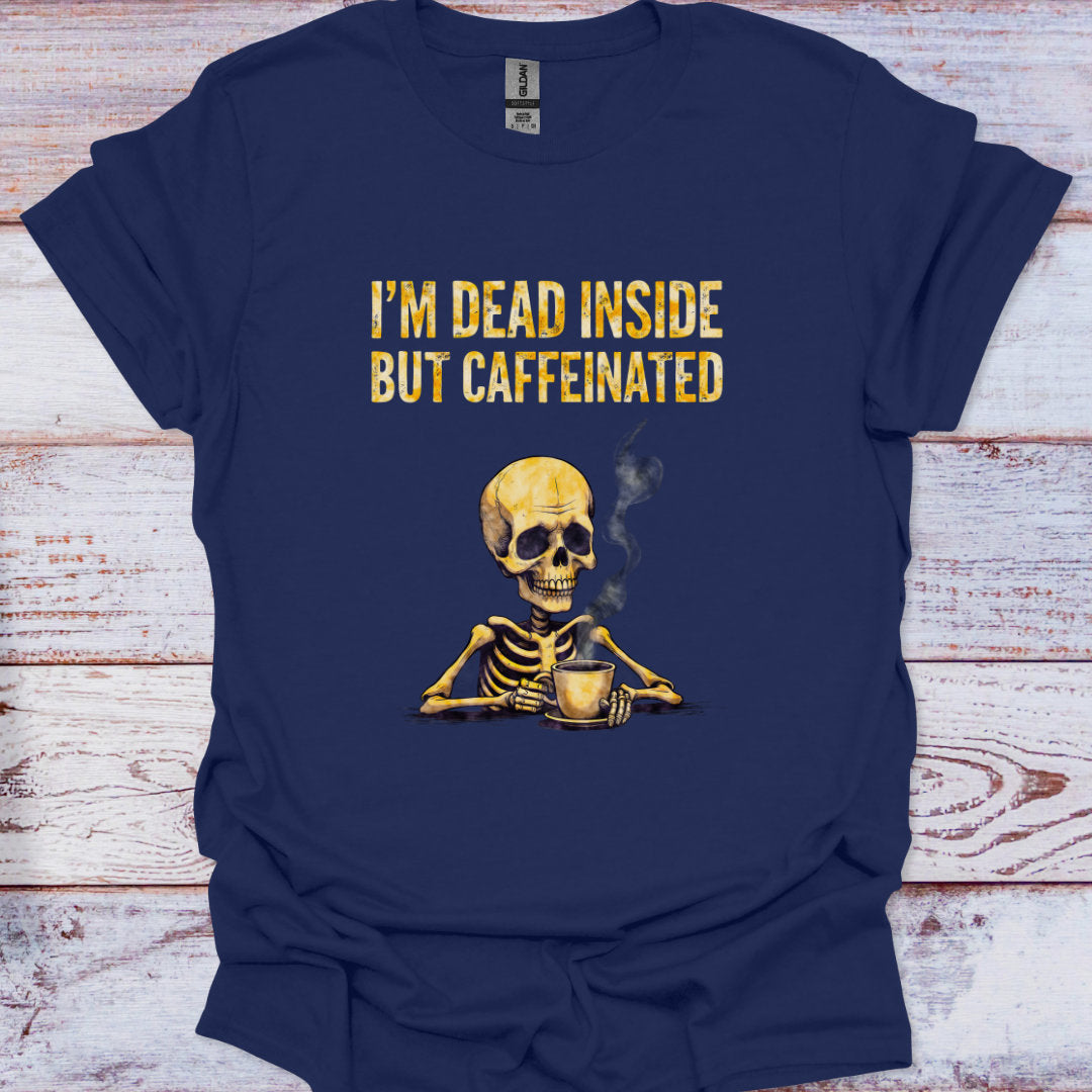 Navy blue t-shirt with a skeleton holding a coffee cup and text 'I'm dead inside but caffeinated' on a wooden surface.