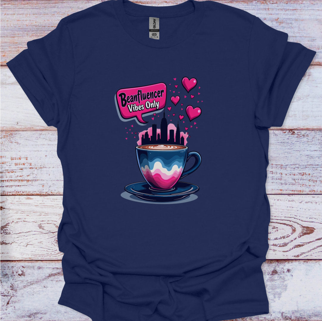 Navy blue t-shirt with a colorful coffee cup graphic and text on a wooden surface
