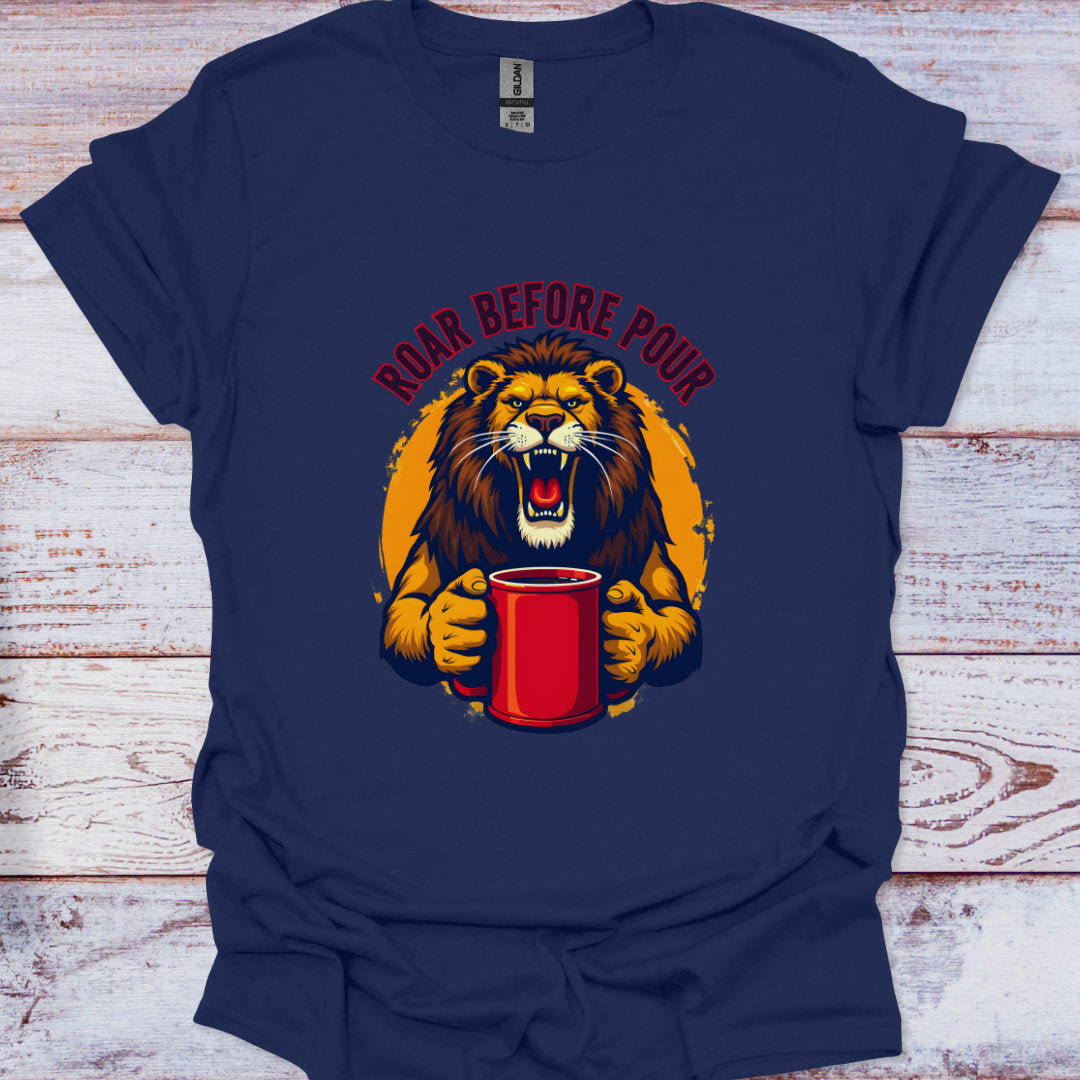 Navy blue t-shirt with a graphic of a lion holding a red cup and 'Roar Before Pour' text on a wooden surface.