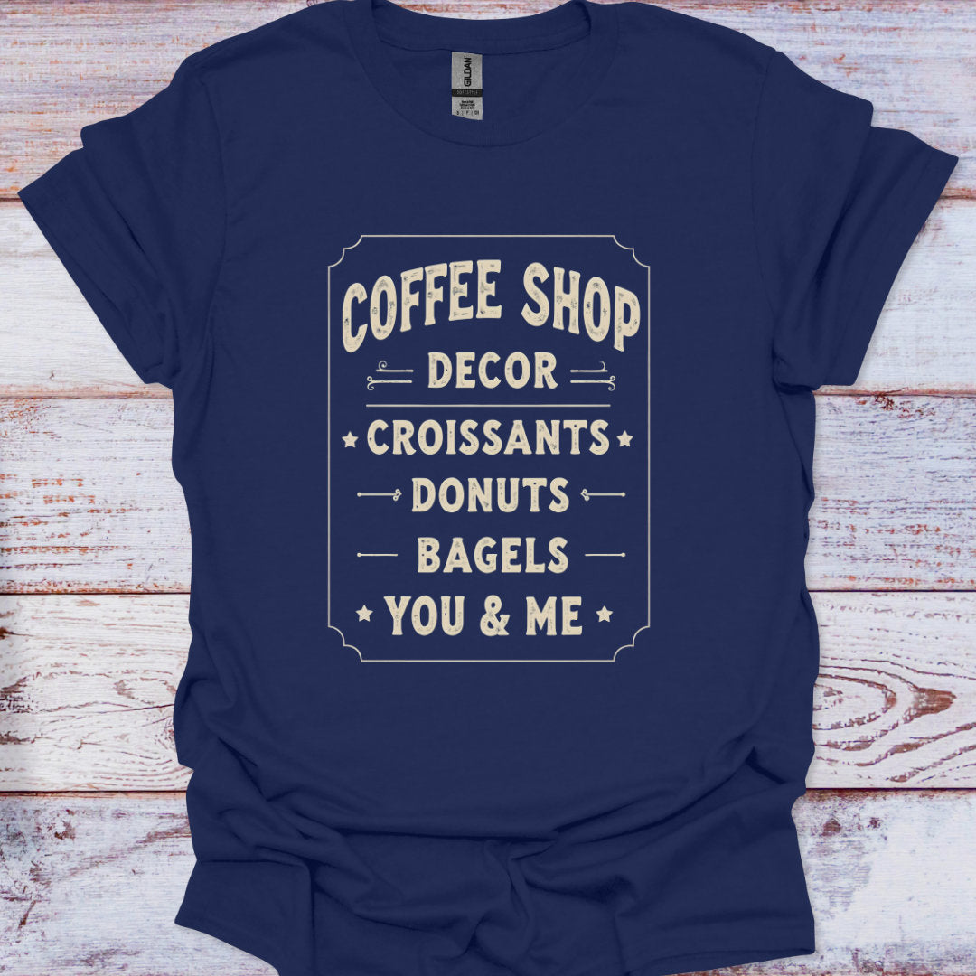 Navy blue t-shirt with white text on a wooden surface
