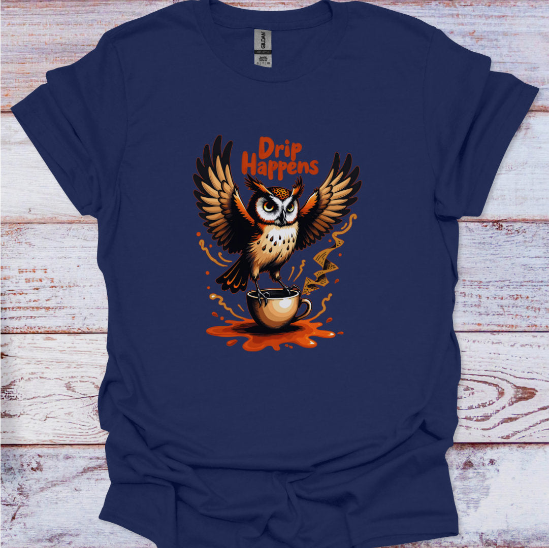 Navy blue t-shirt with an owl holding a coffee cup and 'Drip Happens' text on a wooden surface