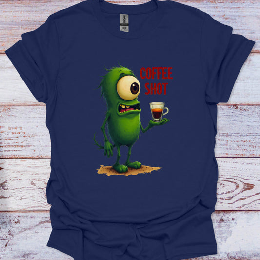 Navy blue t-shirt with a green cartoon character holding a coffee shot on a wooden surface