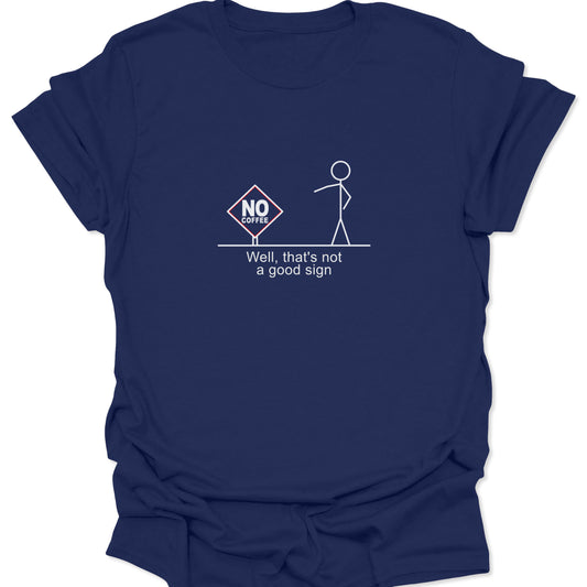 A navy blue t-shirt featuring a crisp white stick figure drawing and a "No Coffee" warning sign, offering high contrast for the sarcastic text underneath.