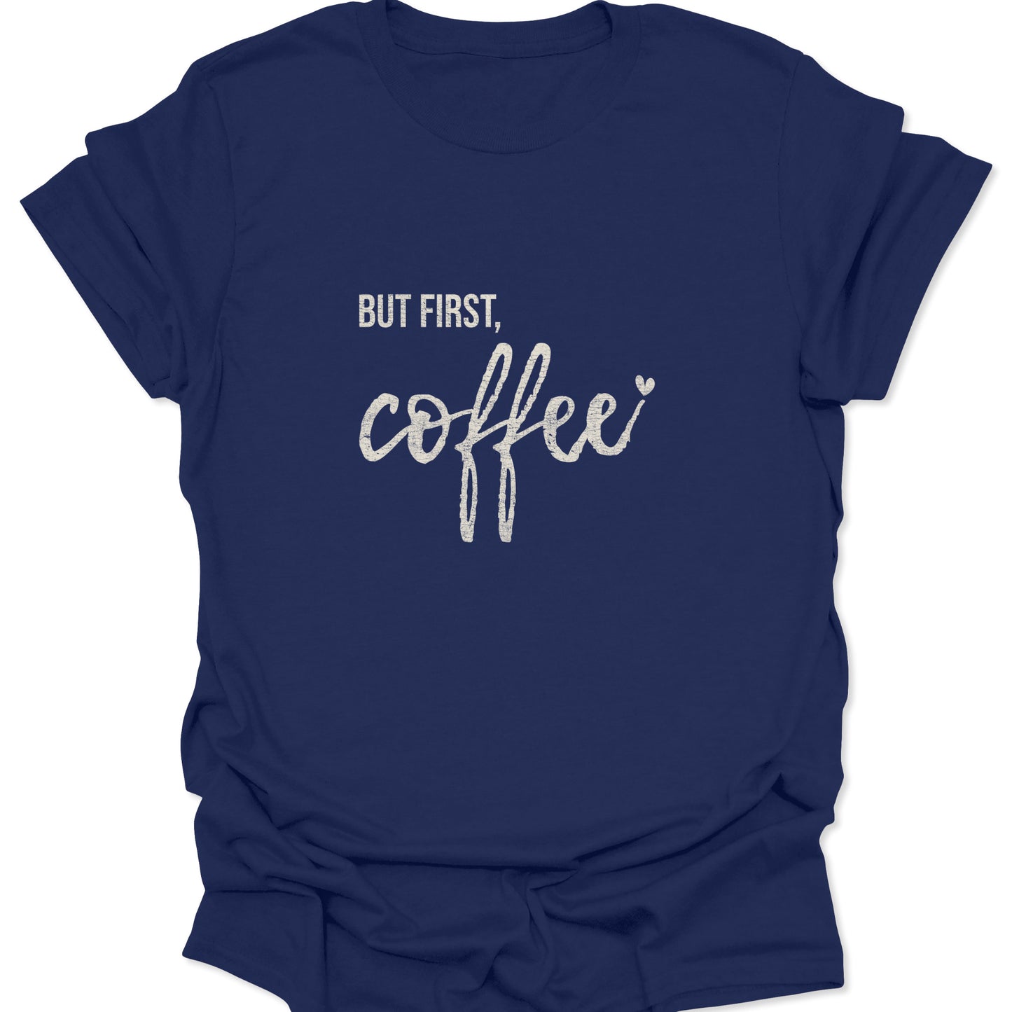 A navy blue graphic tee featuring a high-contrast white distressed print of the slogan "BUT FIRST, coffee" in a stylish script layout.