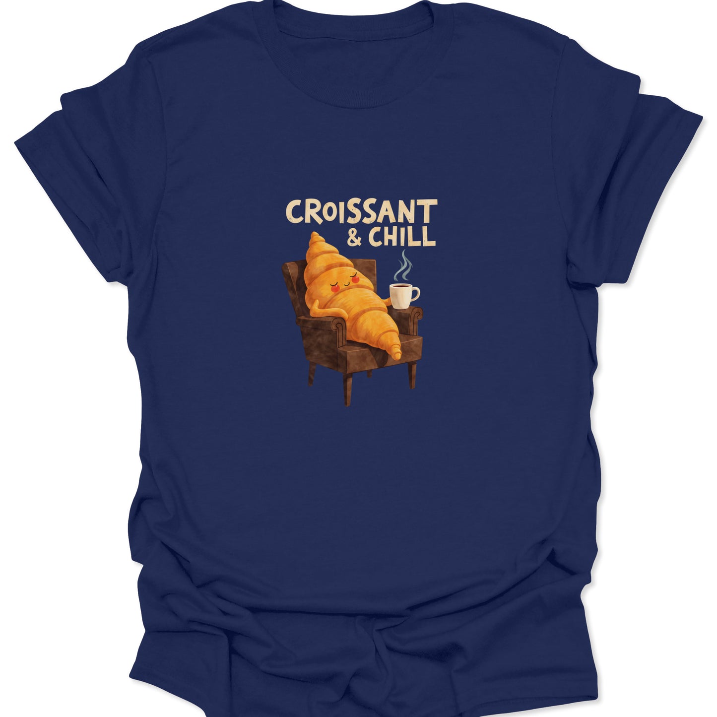 Absurdist bakery graphic tee. A croissant mascot kicking back in a brown armchair with a mug, all set against a rich navy blue t-shirt color.