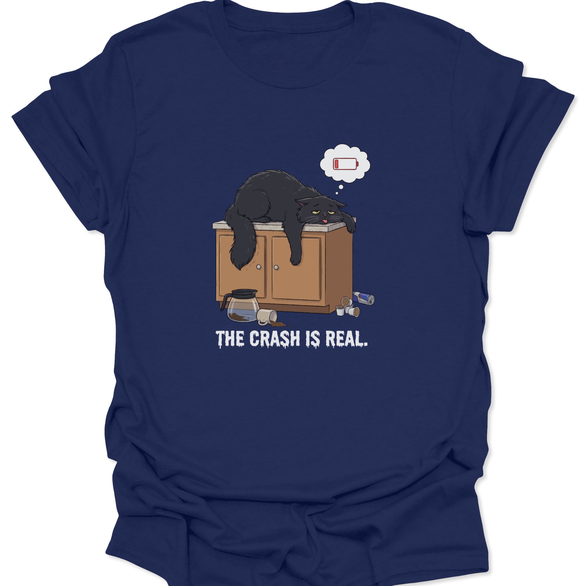 Graphic tee on navy blue fabric showing a tired black cat slumped over a counter with a low battery thought bubble.