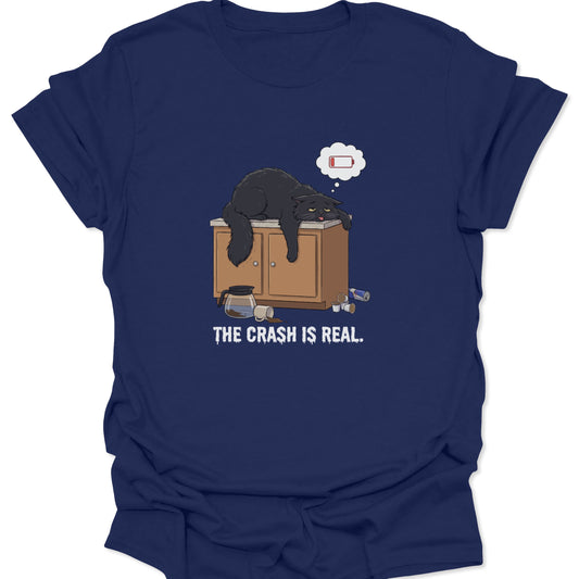 Graphic tee on navy blue fabric showing a tired black cat slumped over a counter with a low battery thought bubble.