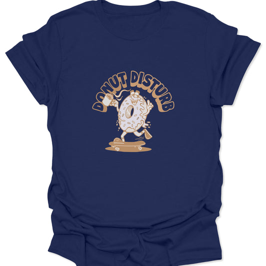 Graphic tee on dark navy fabric featuring a cartoon donut character skateboarding with a coffee mug and "Donut Disturb" text in tan.