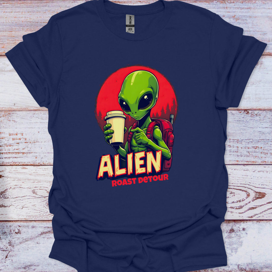 Navy blue t-shirt with an alien graphic holding a coffee cup on a wooden surface