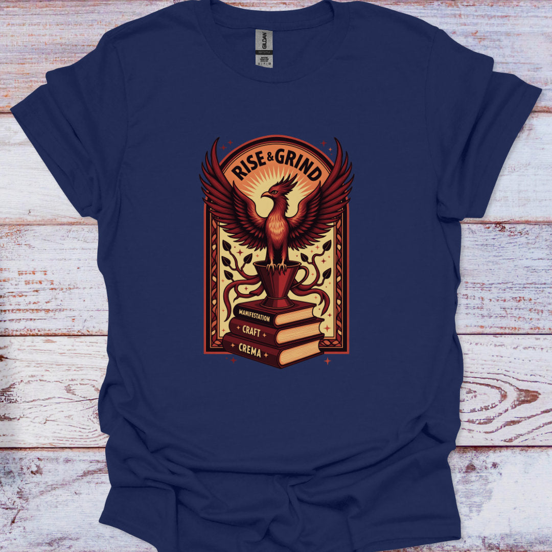 Navy blue t-shirt with a phoenix graphic and 'Rise & Grind' text on a wooden surface