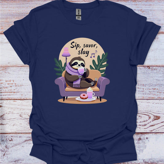 Navy blue t-shirt with a sloth graphic and text 'Sip, savor, slay' on a wooden surface.