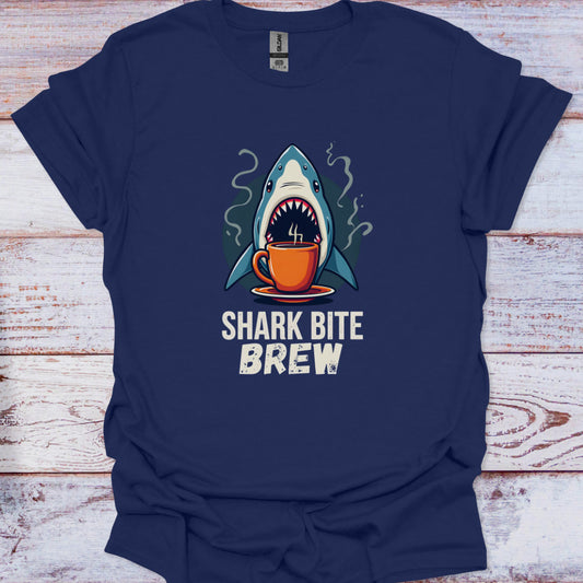 Navy blue t-shirt with a shark drinking coffee graphic and 'Shark Bite Brew' text on a wooden surface.
