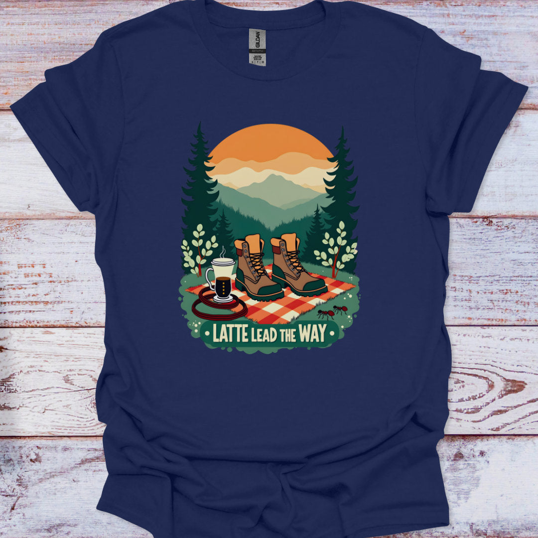 Navy blue t-shirt with a graphic of hiking boots, a coffee cup, and a sunset over trees on a wooden surface.