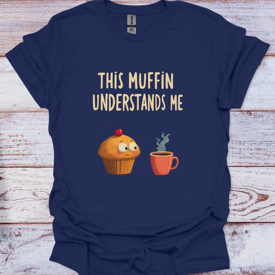 Navy blue t-shirt with a graphic of a muffin and a cup, and text 'This Muffin Understands Me' on a wooden surface.