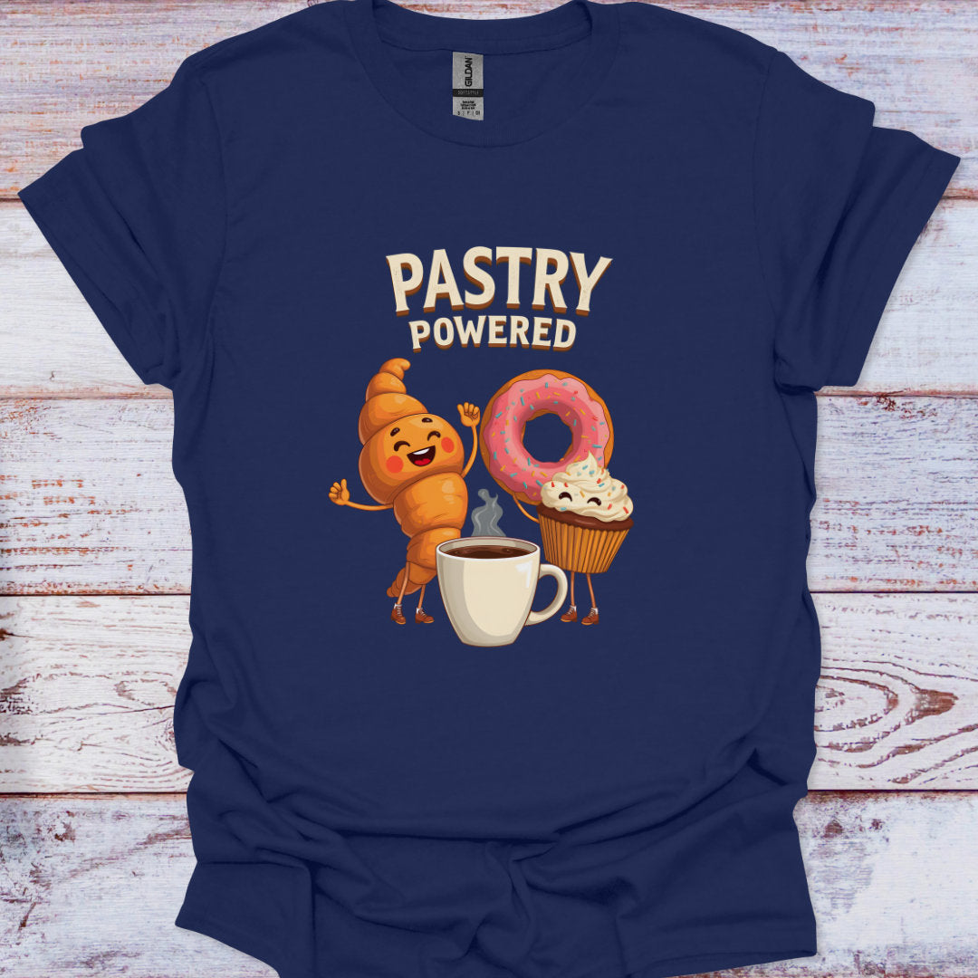 Navy blue t-shirt with cartoon characters and 'Pastry Powered' text on a wooden surface