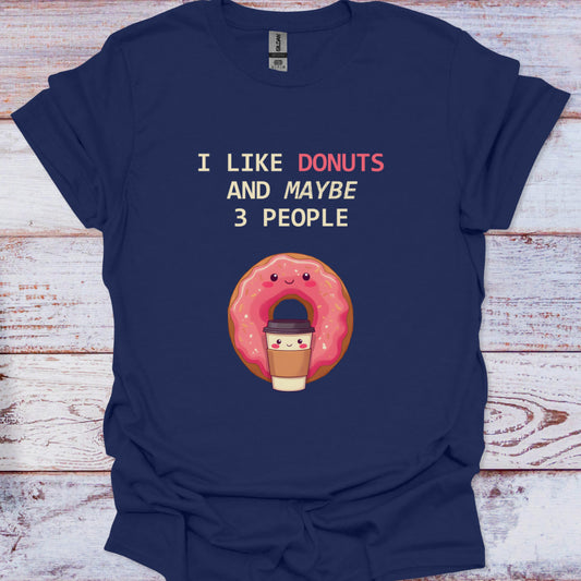 Navy blue t-shirt with a cartoon donut and text on a wooden surface