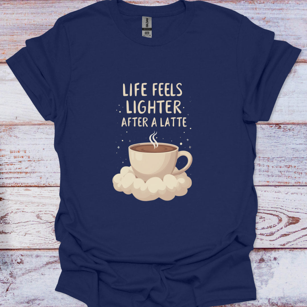 Navy blue t-shirt with a coffee cup graphic and text 'Life feels lighter after a latte' on a wooden surface.
