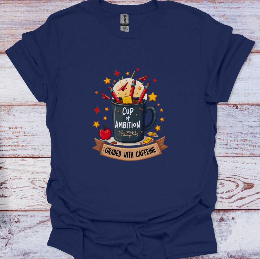 Navy blue t-shirt with a graphic design of a coffee mug labeled 'Cup of Ambition Graded with Caffeine' on a wooden surface.