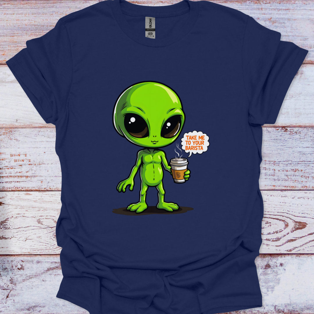 Navy blue t-shirt with a green alien holding a coffee cup graphic on a wooden surface