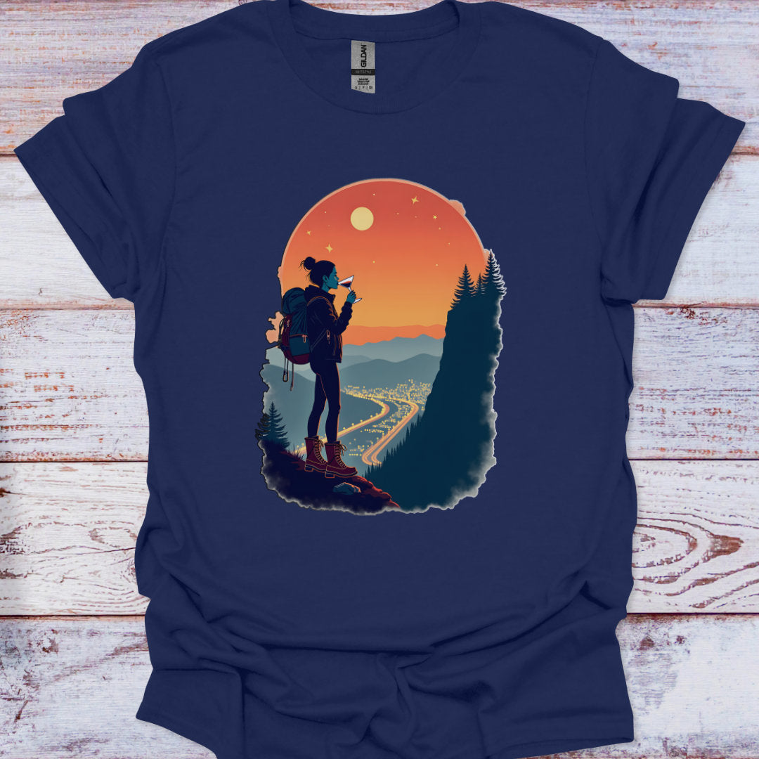Navy blue t-shirt with a graphic of a hiker and sunset design on a wooden surface