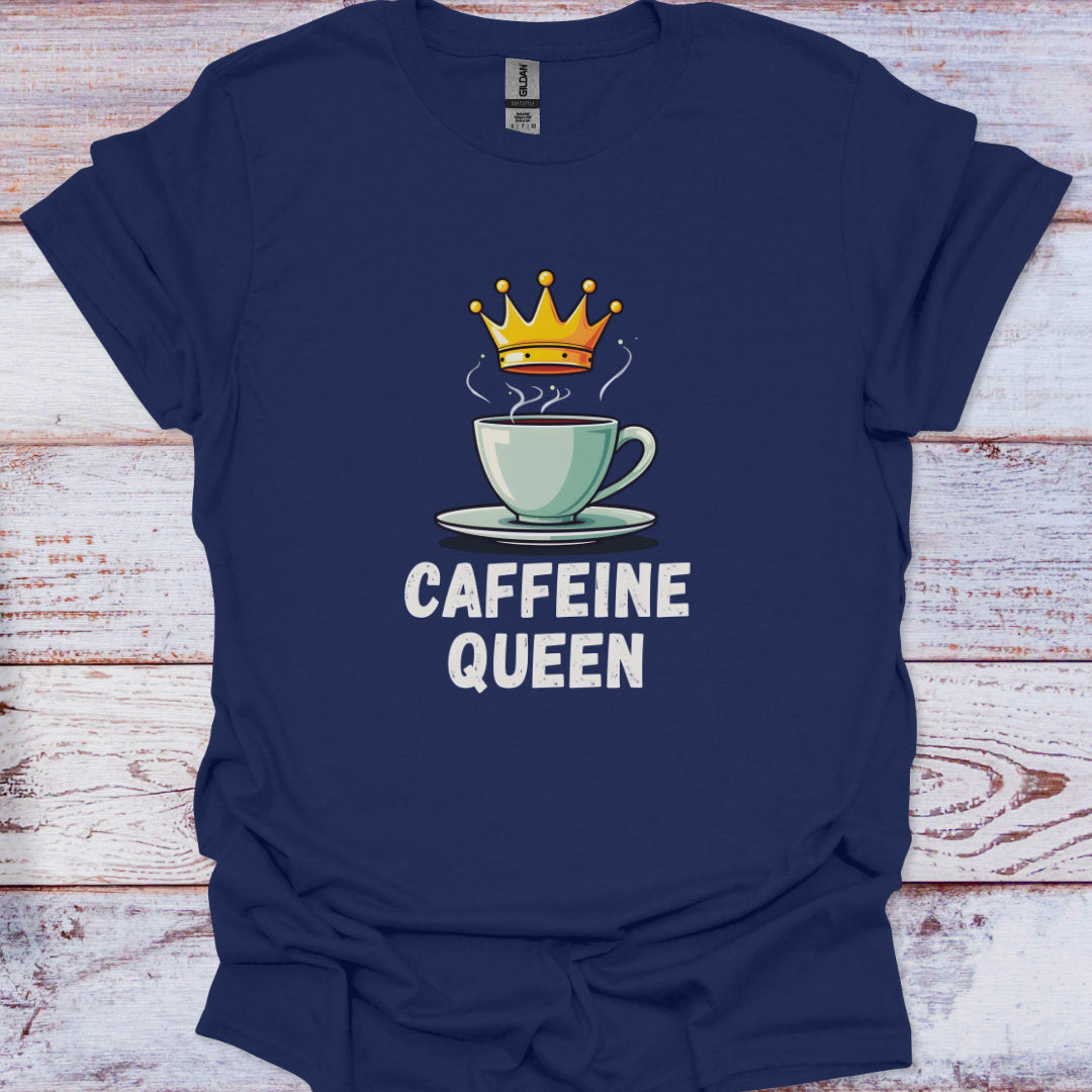 Navy blue t-shirt with a graphic of a coffee cup with a crown and text 'CAFFEINE QUEEN' on a wooden surface.