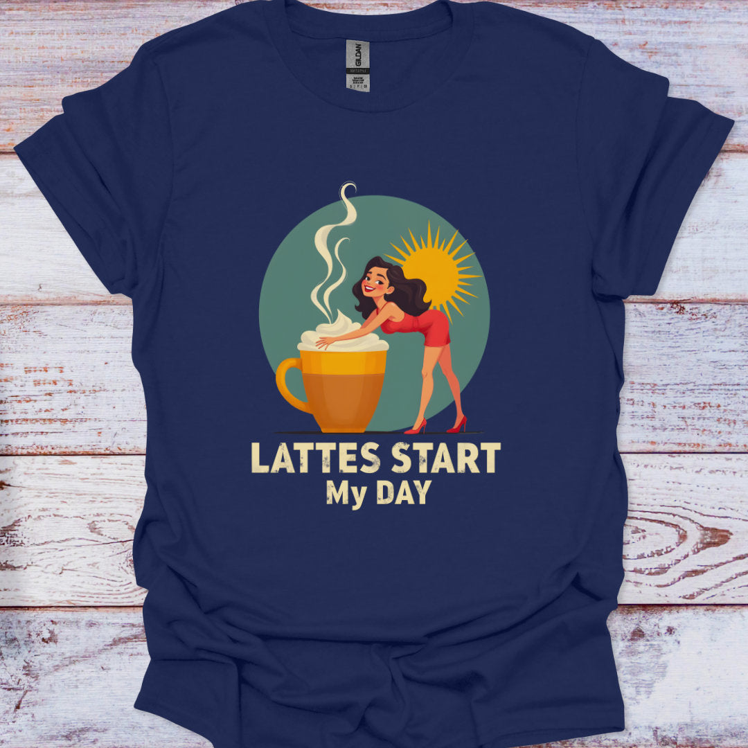 Navy blue t-shirt with a graphic of a woman by a coffee cup and text 'Lattes Start My Day' on a wooden surface.