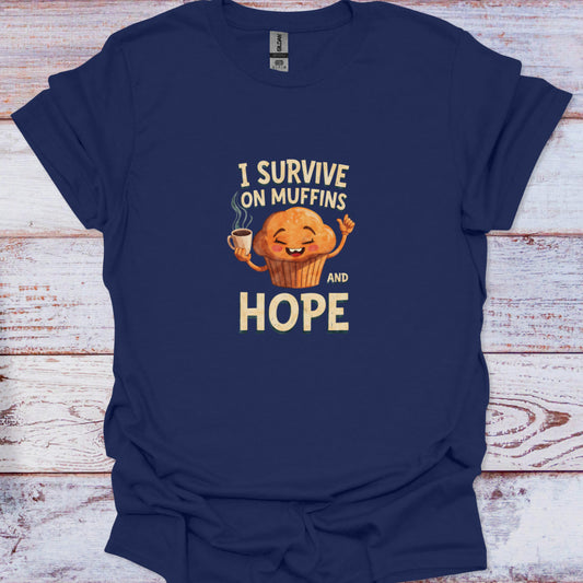 Navy Blue tee featuring a whimsical bakery design with the quote I Survive on Muffins and Hope.