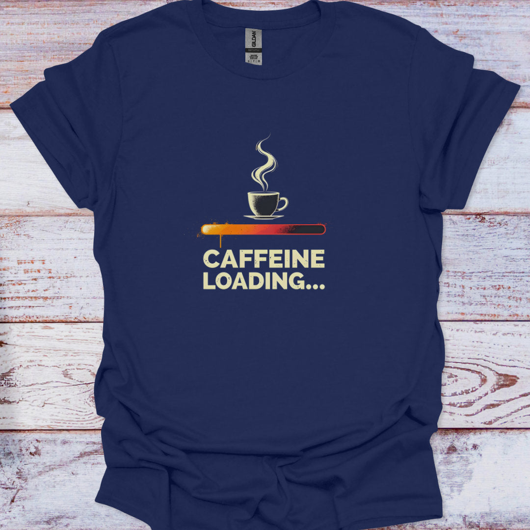 Navy blue t-shirt with a coffee cup graphic and 'CAFFEINE LOADING...' text on a wooden surface