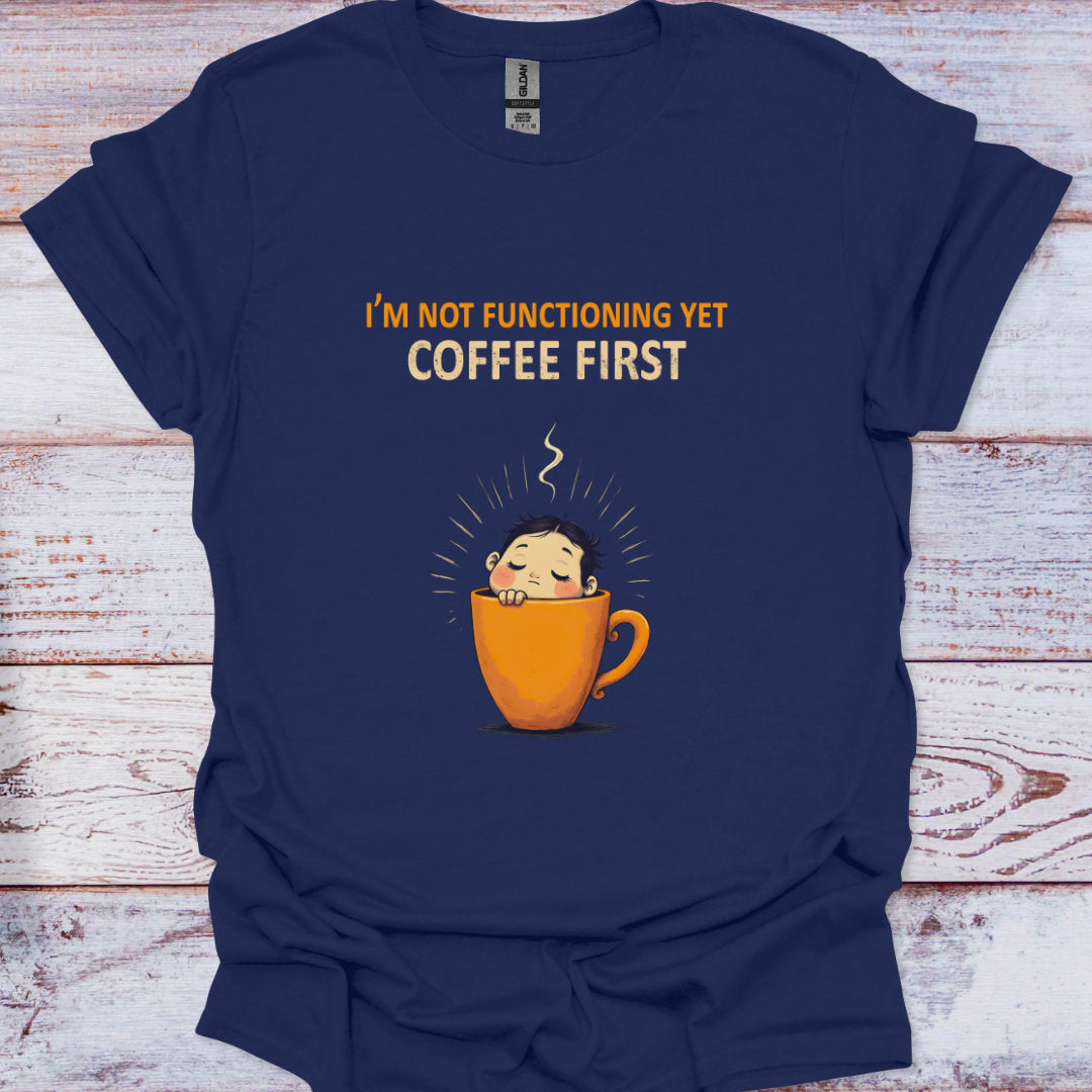 Navy blue t-shirt with a coffee cup graphic and text on a wooden surface