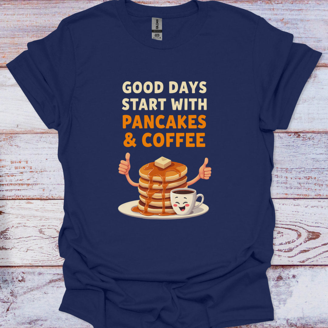 Navy blue t-shirt with 'Good days start with pancakes & coffee' design on a wooden surface