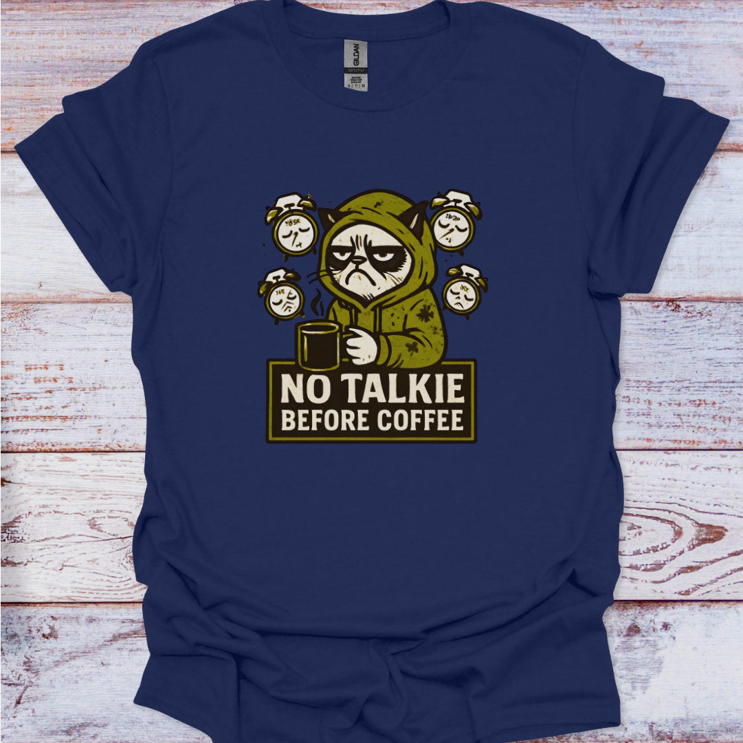 Navy blue t-shirt with a graphic of a character holding a coffee cup and text 'No Talkie Before Coffee' on a wooden surface.