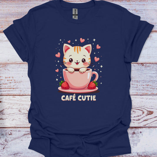 Navy blue t-shirt with a cartoon cat in a coffee cup design and 'Café Cutie' text on a wooden surface.