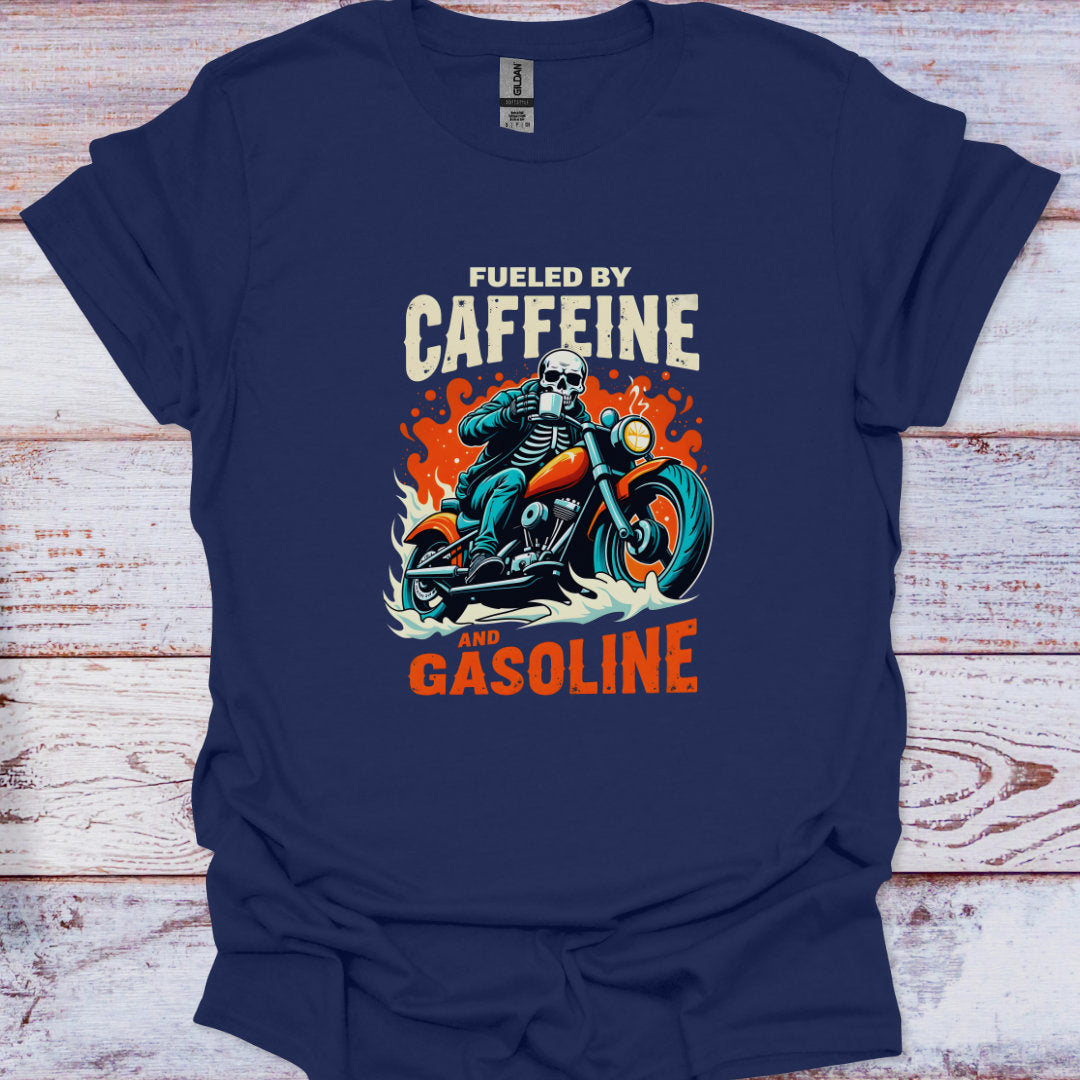 Navy blue t-shirt with a graphic of a skeleton on a motorcycle and text 'Fueled by Caffeine and Gasoline' on a wooden surface.