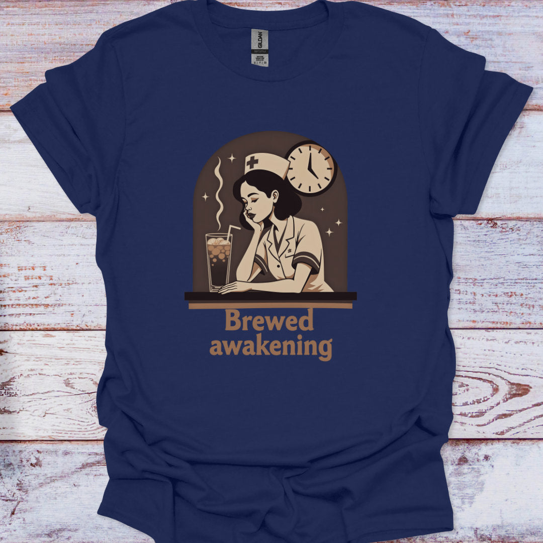 Navy blue t-shirt with a graphic of a woman at a desk with a drink and a clock, labeled 'Brewed Awakening', on a wooden surface.