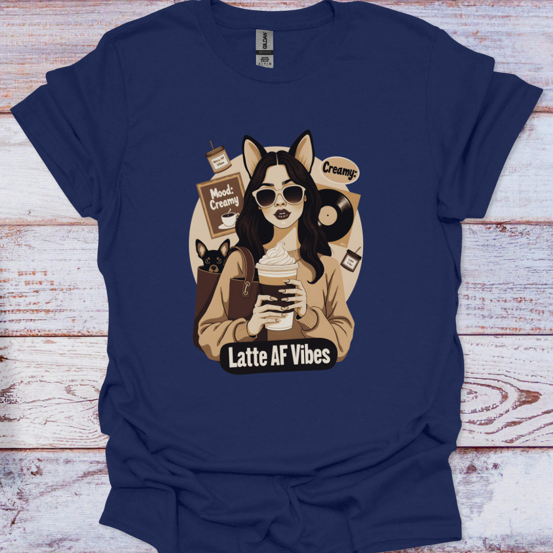 Navy blue t-shirt with a graphic of a person holding a coffee cup and text 'Latte AF Vibes' on a wooden surface.