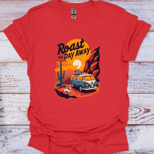 Red t-shirt with a graphic design of a van, cactus, and sunset on a wooden surface