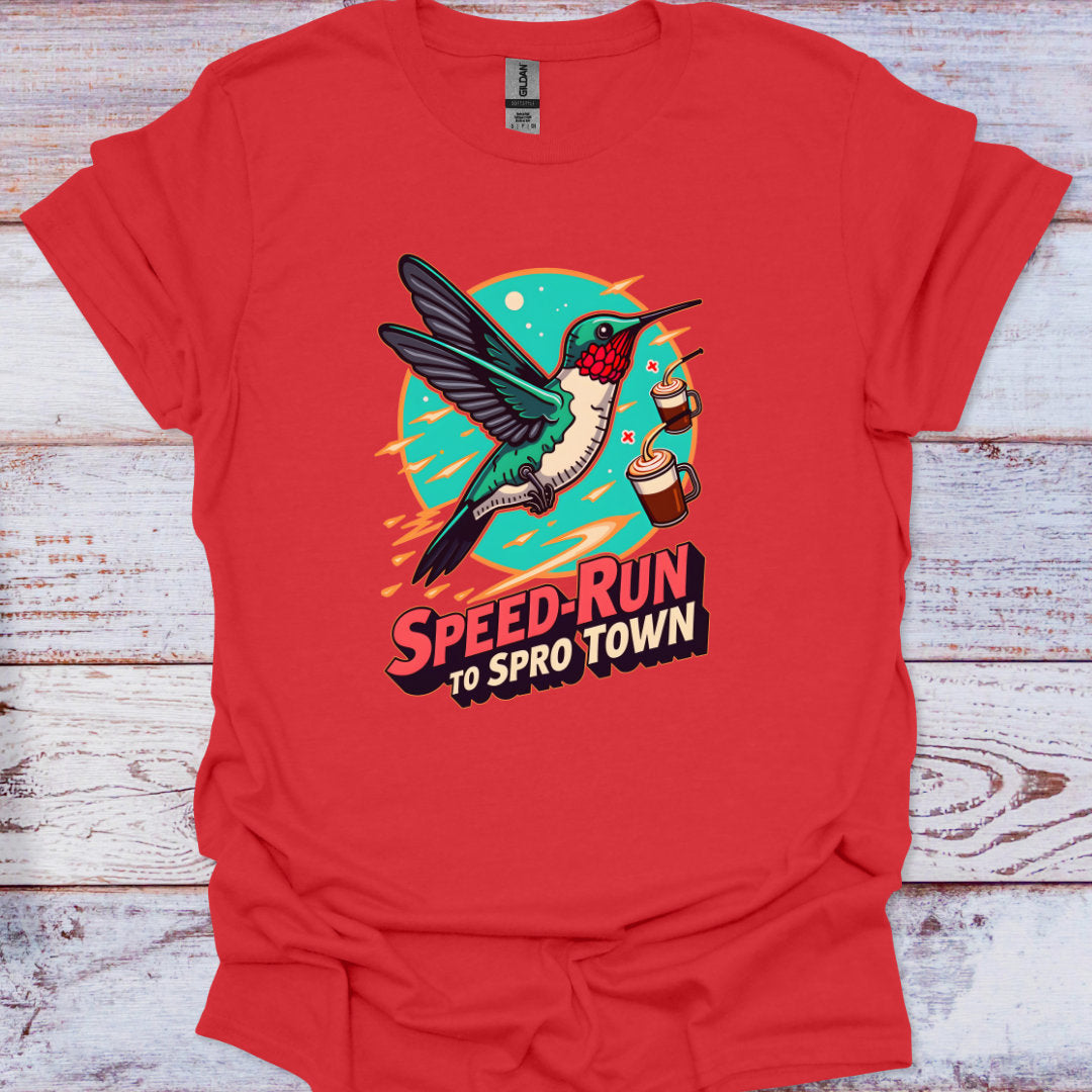 Red t-shirt with a colorful graphic of a hummingbird and text on a wooden surface