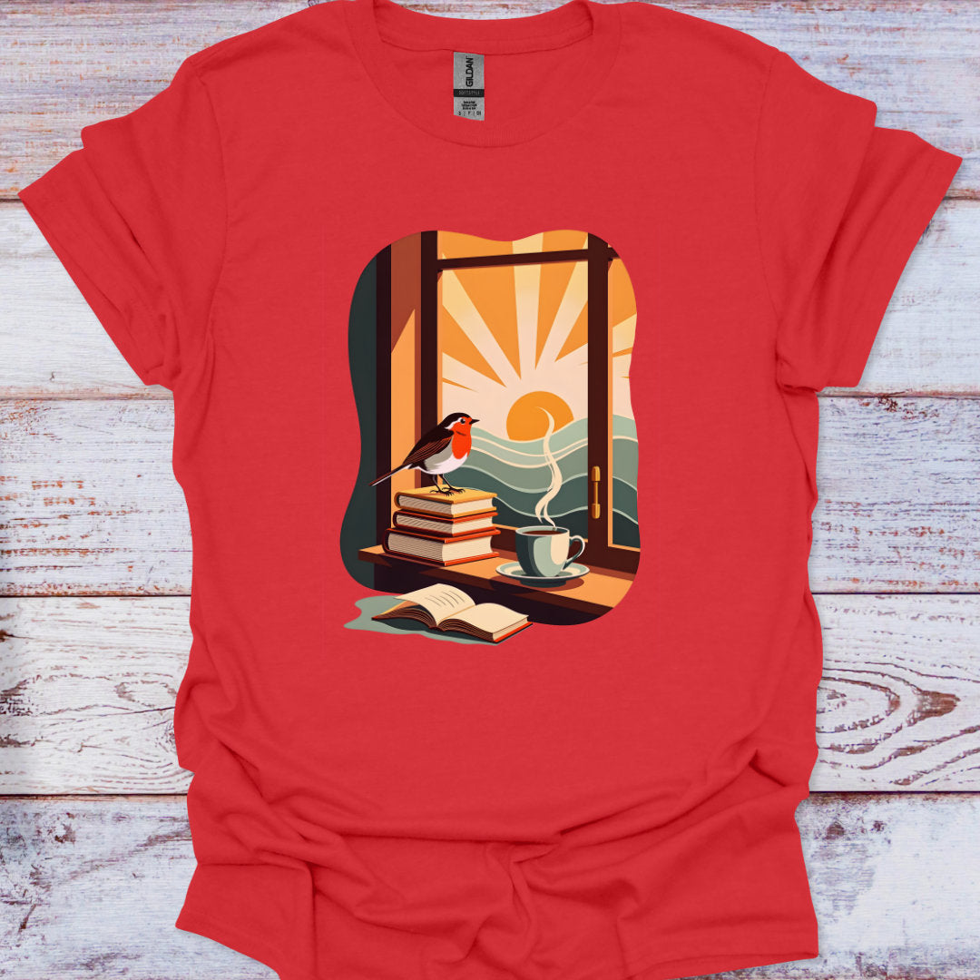 Red t-shirt with a graphic of a window scene with books, a cup, and a bird on a wooden surface.