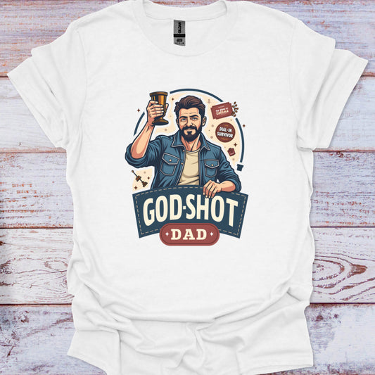 White t-shirt with a graphic of a man holding a beer mug and 'GOD-SHOT DAD' text on a wooden surface.
