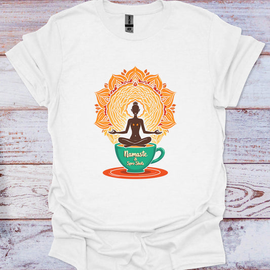 White t-shirt with a colorful design of a person meditating in a coffee cup on a wooden surface