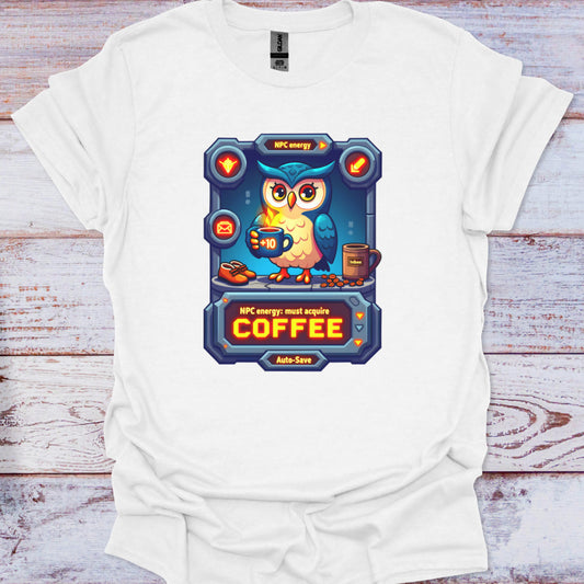 White t-shirt with a colorful graphic of an owl holding a coffee cup on a wooden surface