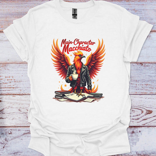 White t-shirt with a graphic of an eagle holding a cup and text 'Main Character Macchiato' on a wooden background